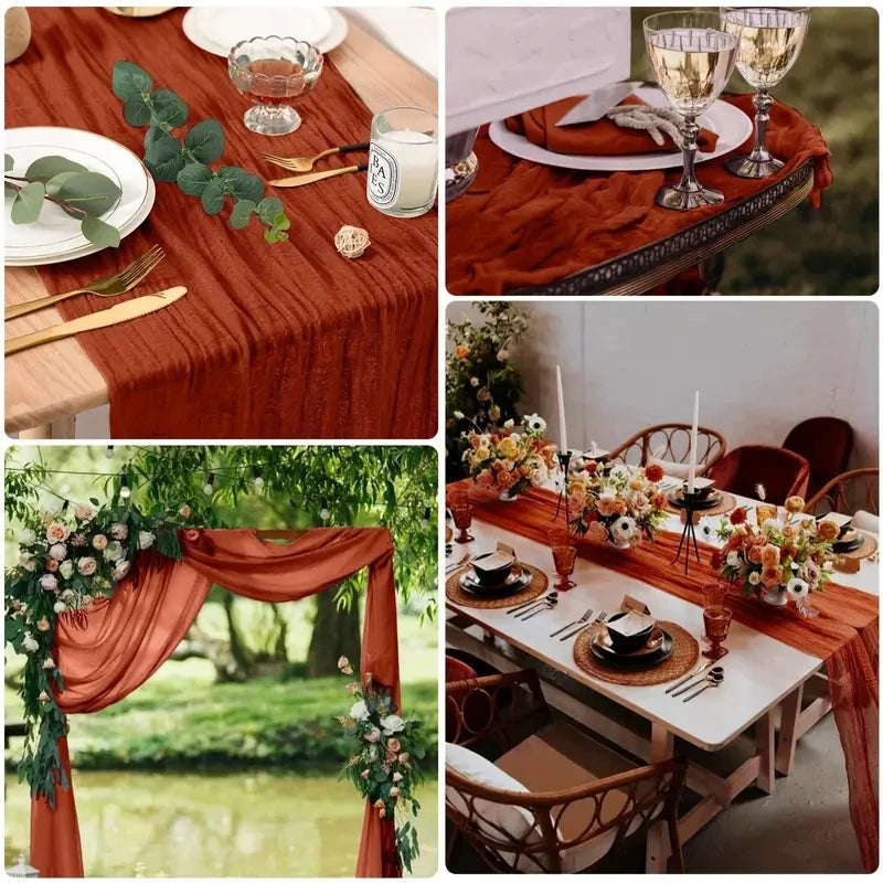 A close-up of a rustic wooden table set for a meal with a terracotta runner, glassware, and cutlery.