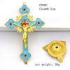 A gold and blue cross crucifix with a figure of Jesus, presented on a white background.