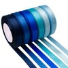 A roll of satin silk ribbon in various shades of blue and teal, with several ribbons unwound below.