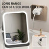 A long range filling vanity mirror with a rectangular frame and LED lights is shown next to a power outlet.