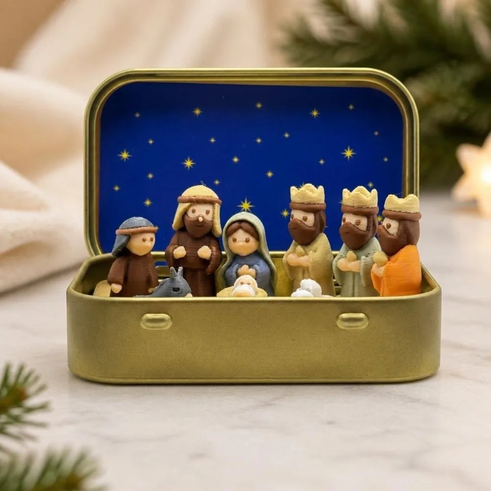 A hand-painted mini nativity set featuring figures in a gold tin storage box against a blue starry background.