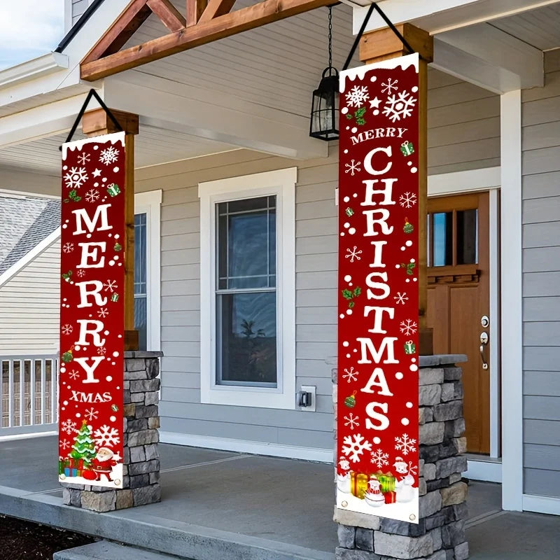 Two vertical red Christmas banners with white snowflakes and green holly accents displayed on stone pillars.