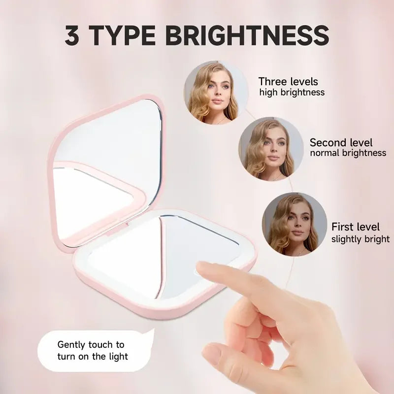 A pink portable folding makeup mirror with an LED light showing three brightness levels.