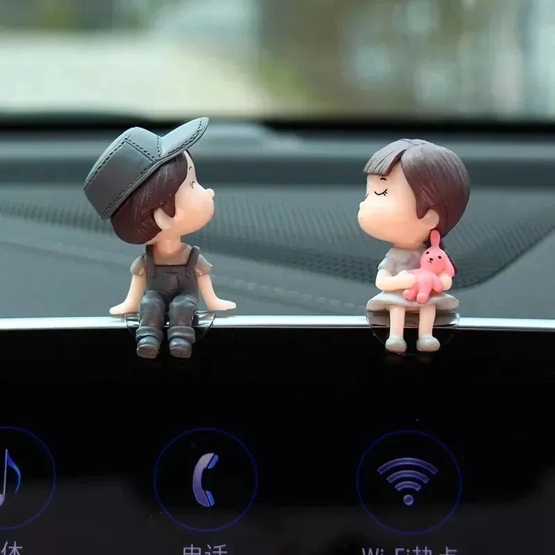 A set of cute couple balloon car ornaments featuring a boy and a girl figurine.