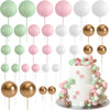 A collection of gold and silver foam ball cake toppers in various shades and sizes for party decorations.