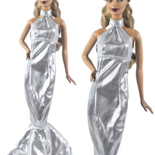 Silver satin mermaid gown for a doll featuring a high neck and ruffled skirt.