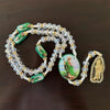 Green crystal rosary necklace featuring Saint Jude and Virgin Mary cross pendants