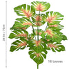 Artificial Monstera plant with silk leaves showing green and pink variegation.