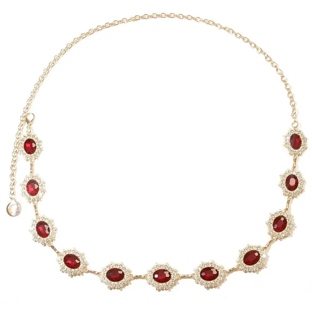 A delicate gold waist chain featuring red crystal accents.