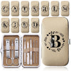 A set of eight metal manicure and pedicure tools is displayed alongside a beige leather case.