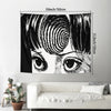 Black and white tapestry wall hanging depicting a close-up of a human eye and surrounding features.