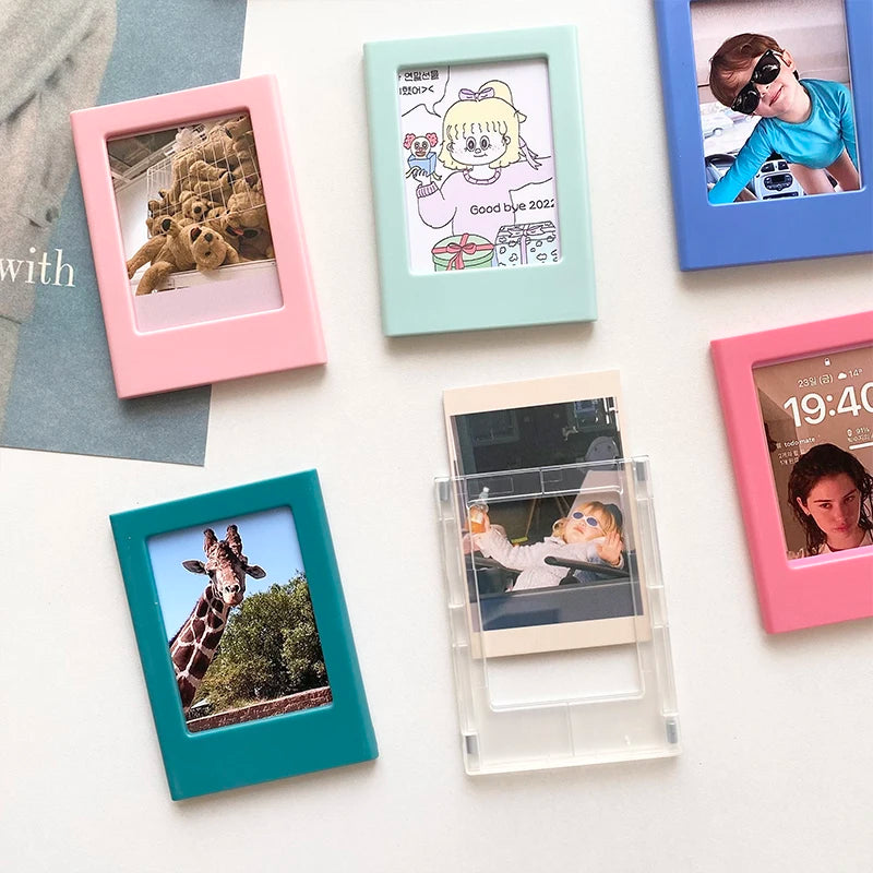 A collection of colorful magnetic photo frames displaying various small photographs.
