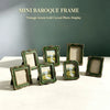 A collection of mini baroque frames in vintage green and gold carving displayed on a white surface.