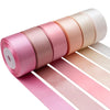 Roll of satin silk ribbon in various shades of pink and beige for crafting