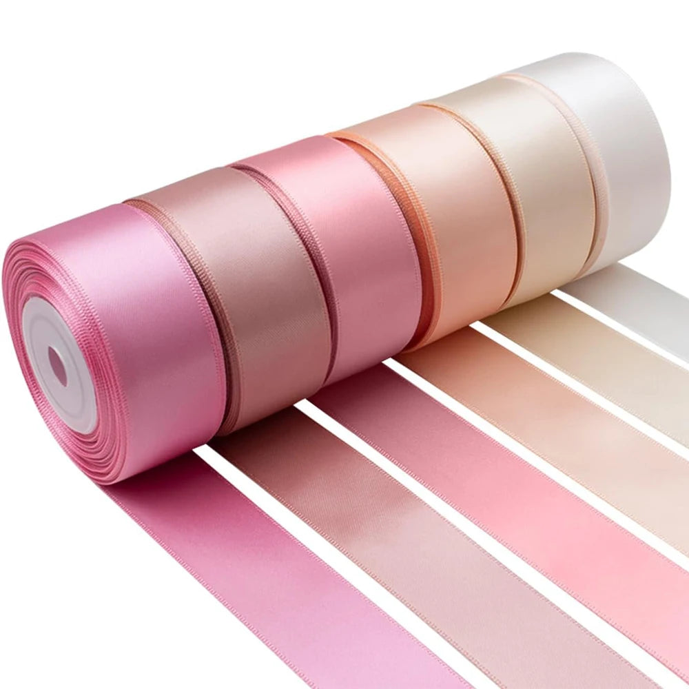 Roll of satin silk ribbon in various shades of pink and beige for crafting