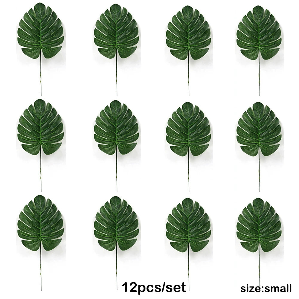 Twelve artificial tropical palm leaves in various shades of green displayed for party decor