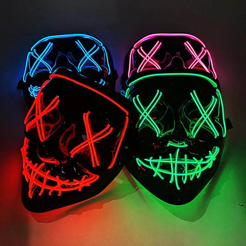 A pair of glow-in-the-dark LED purge masks with neon wire details illuminated against a dark background.