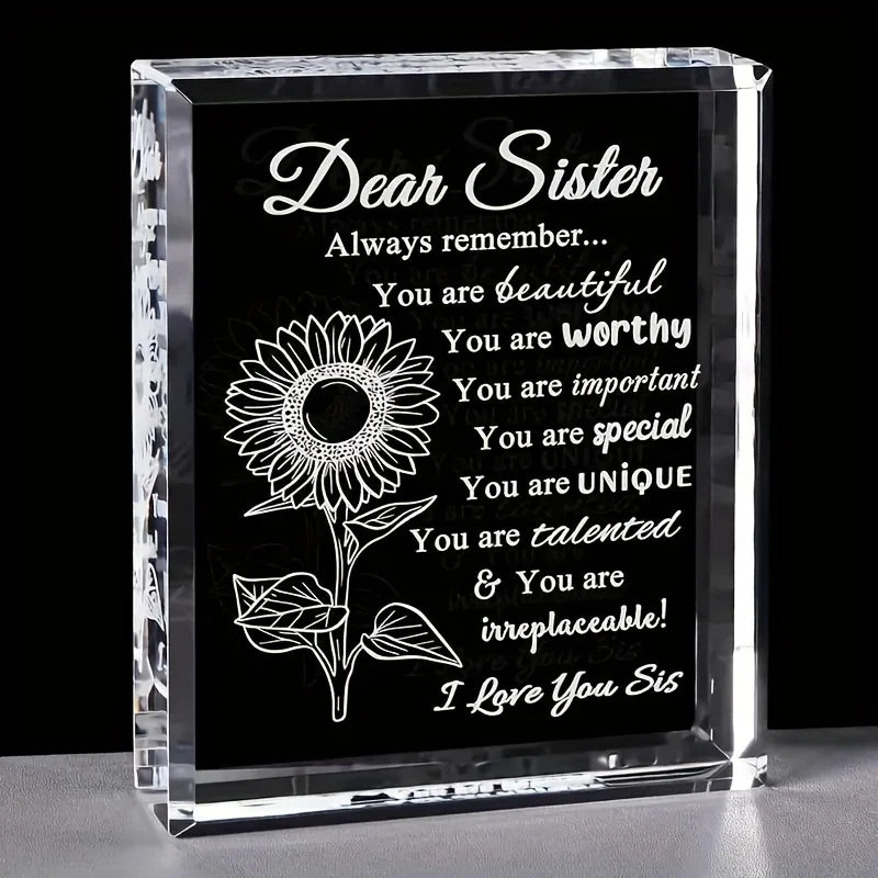 A clear crystal keepsake box with engraved text reading Dear Sister and compliments about her beauty and unique talents.