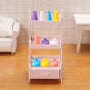 A pink tiered shelf display of colorful miniature resin vases for dollhouse decor.
