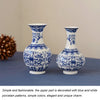 Blue and white ceramic flower vase with intricate patterns on a dark blue surface.