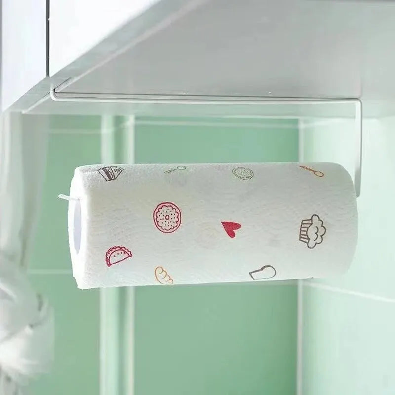 A roll of white paper towels decorated with small red and brown icons is held in a clear plastic holder.