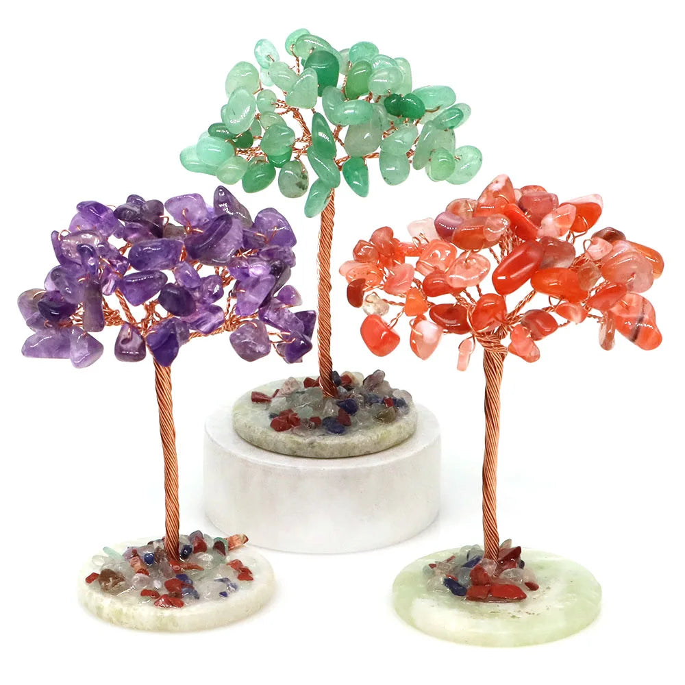A display of three natural crystal money trees featuring green, purple, and orange-red crystals on copper wire stems.