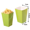 A lime green disposable paper cup with a fluted rim, holding small, light-colored snacks.