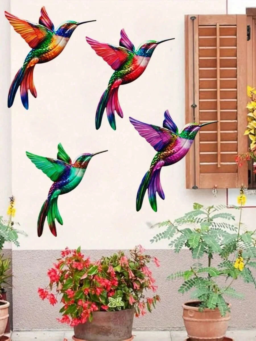 Set of four metal hummingbird wall decor featuring vibrant iridescent colors mounted on a white wall.