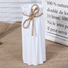 Modern white plastic vase with a basket design tied with twine, standing next to informational text.