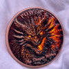 A round copper challenge coin featuring a fierce dragon head design.