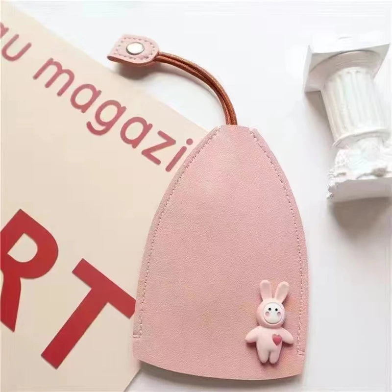 A pink cartoon PU leather key holder with a pull-out design attached to a card.