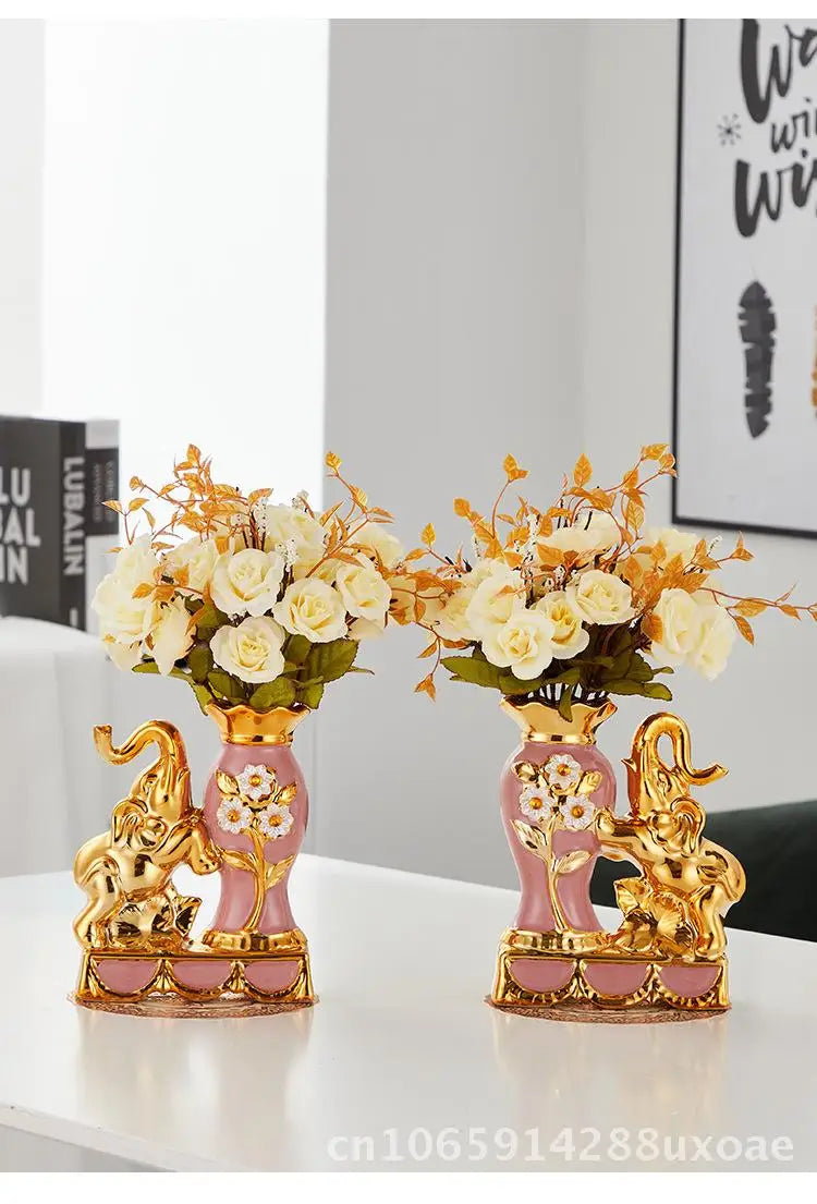 A pair of elegant ceramic vases shaped like swans with gold accents and floral arrangements.