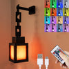 A black pixel lantern night light fixture mounted on a wall, with an illuminated square and a grid of multi-colored lights.