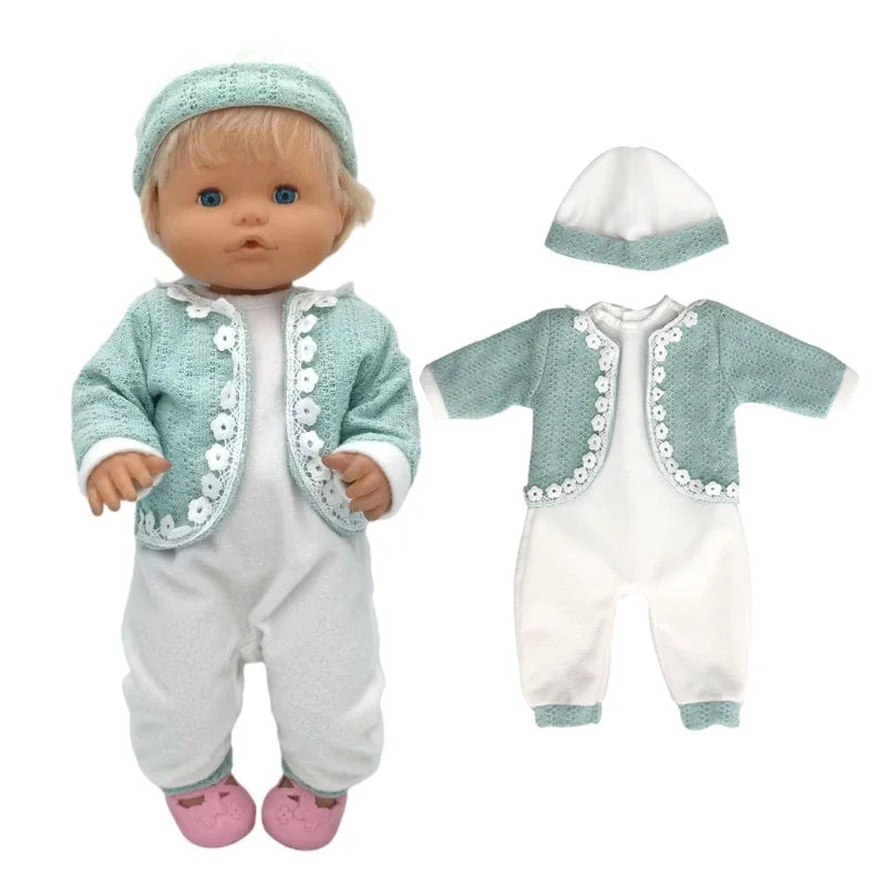 A baby doll outfit set including a light blue knitted hat and matching white clothing with green trim.