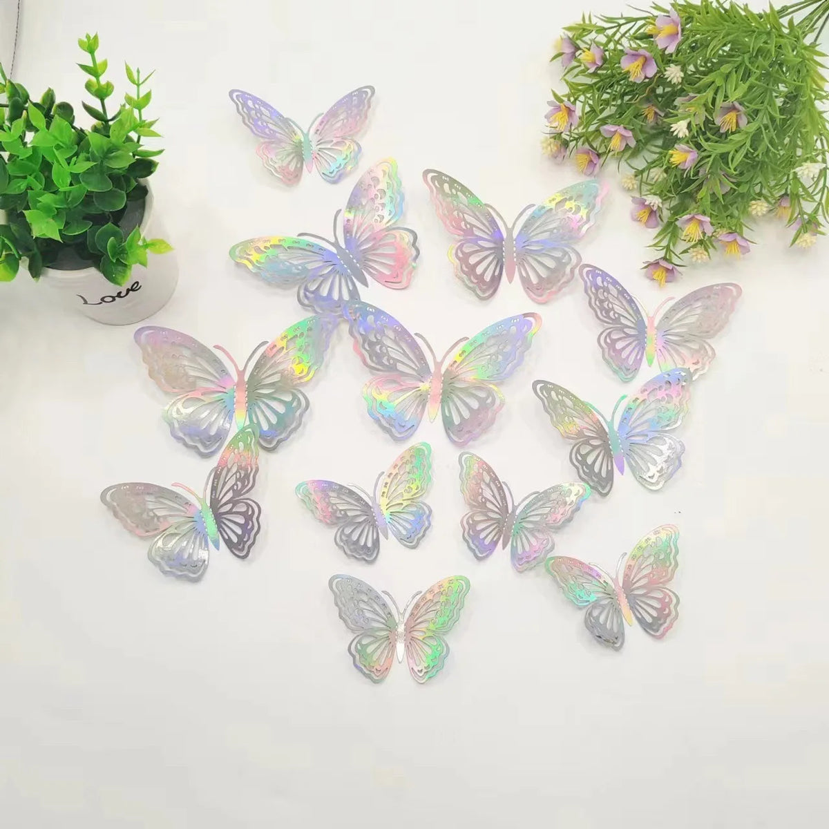 A set of twelve iridescent, holographic butterfly wall stickers scattered on a white background.