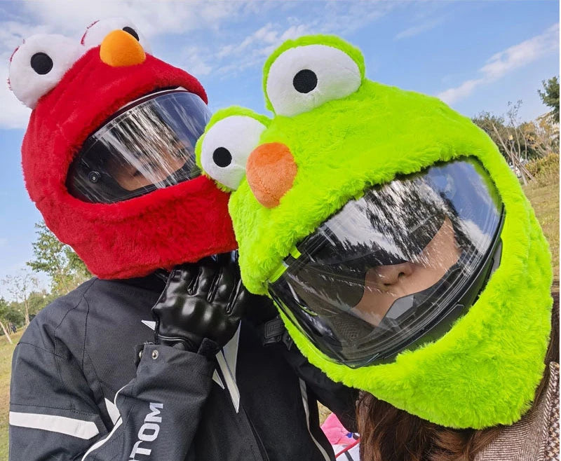 A person wearing a bright lime green cartoon plush helmet cover for a full-face motorcycle helmet.