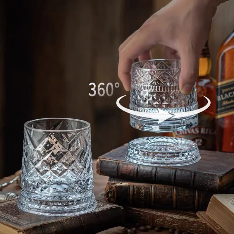 A hand rotates a crystal whiskey glass featuring a relief design, demonstrating 360-degree view.