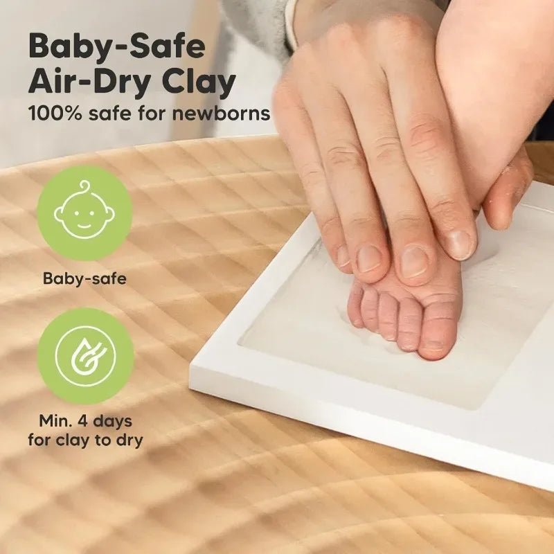 A hand placing a foot into a white frame for a baby-safe air-dry clay keepsake.
