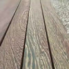 Close-up view of several parallel wooden planks with varied grain and color patterns.