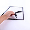 A hand is adjusting a black magnetic poster display frame with a clear plastic cover.