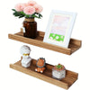 A rustic floating wood shelf set featuring a glass jar with pink flowers and a framed watercolor painting.