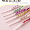 A set of six white base holders with a dripless wax design for birthday candles.