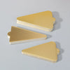 A stack of metallic gold dessert cake boards with silver edges, shown from a side angle.