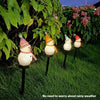 Outdoor decoration featuring several white snowman lights in a garden setting for rain and sun protection