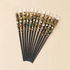 A collection of natural clear quartz zodiac crystal wands with various colored beads and gold accents.