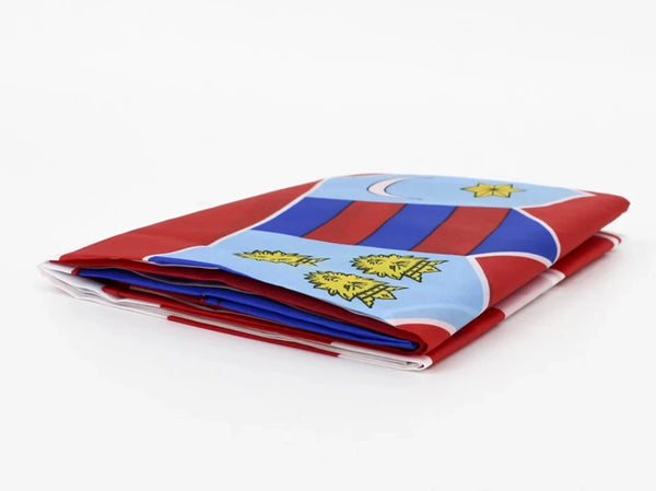 A folded flag banner featuring blue, red, and white stripes with yellow stars on a wooden pole.