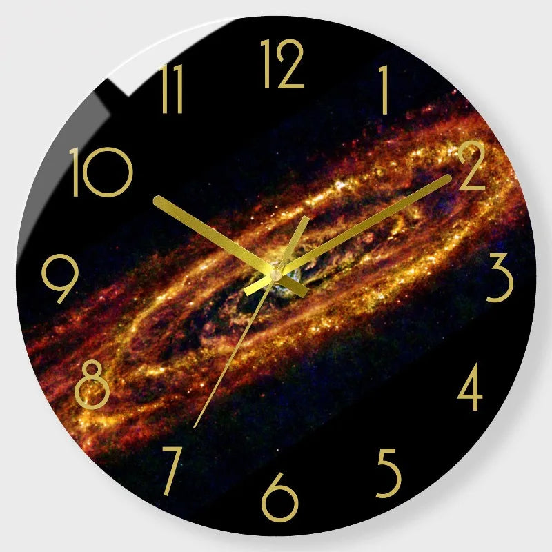 A round clock face displaying a vibrant, swirling galaxy pattern with gold hour markers.