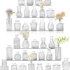 A collection of vintage bud glass vases in various shapes and sizes arranged in a vertical display.