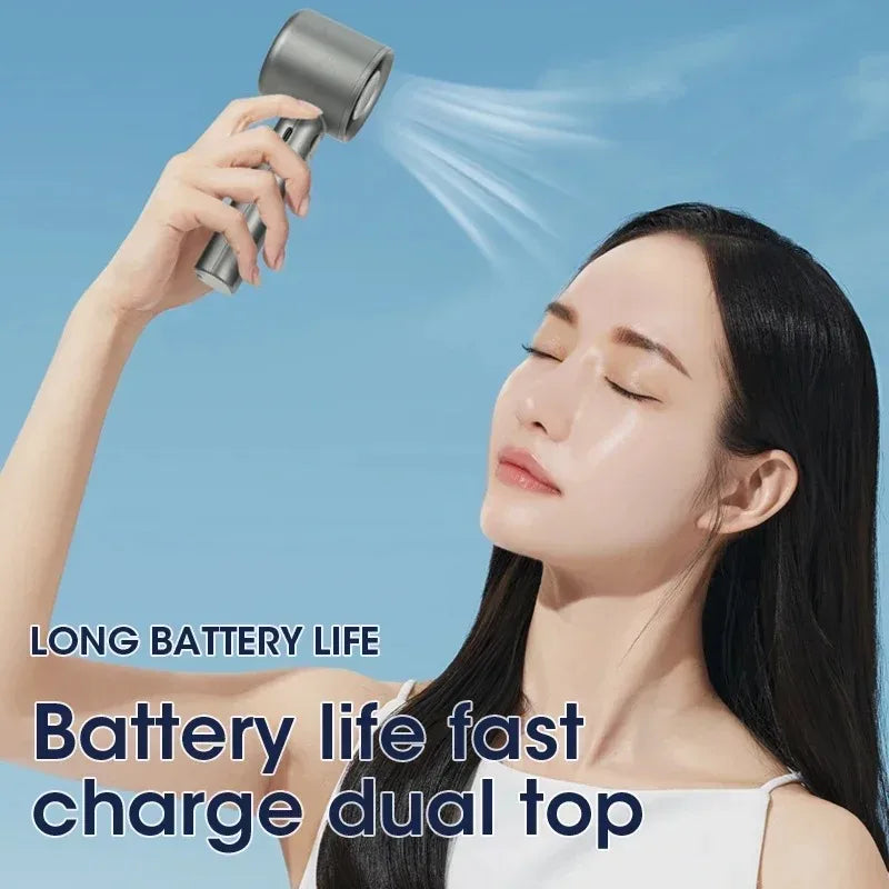 A woman is using an adjustable mini handheld cooling fan to blow air onto her face.