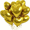 A bunch of gold heart-shaped foil balloons tied together with ribbons.